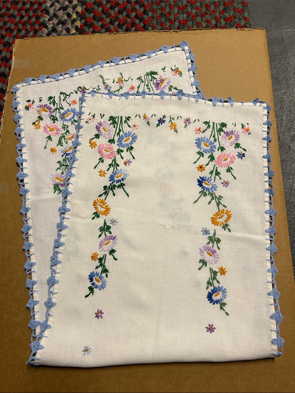 Floral Embroidered White Linen Table Runner with Blue crocheted trim.